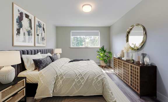 A bedroom with a large bed and a mirror on the wall.