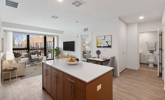 A modern kitchen with a white countertop and wooden cabinets.