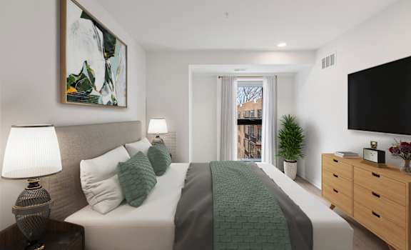 A bedroom with a large bed, a nightstand with a lamp, a plant, and a painting on the wall.