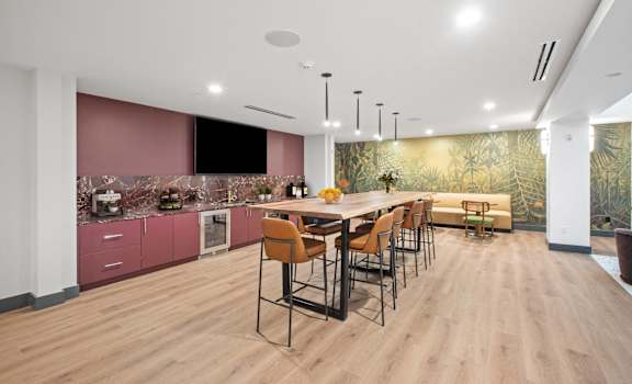 A modern kitchen with a dining table and chairs.