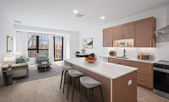 A modern kitchen with a white countertop and wooden cabinets.