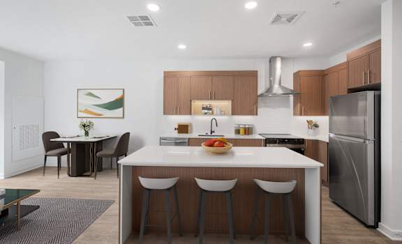 A modern kitchen with a dining table and chairs.