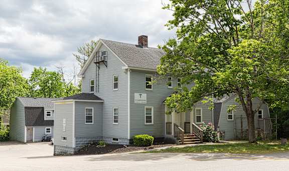 a large gray house with a gray roof