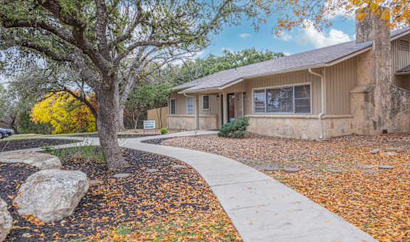 A house with a tree in front of it.