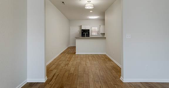 A room with wooden floors and white walls.