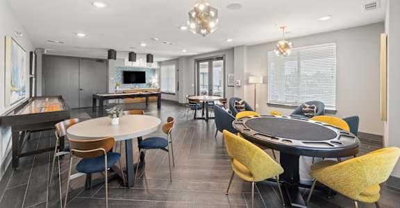 A modern dining room with a large table and chairs.