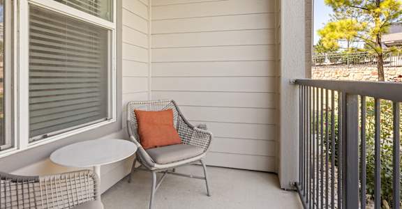 A patio with a chair and a table.