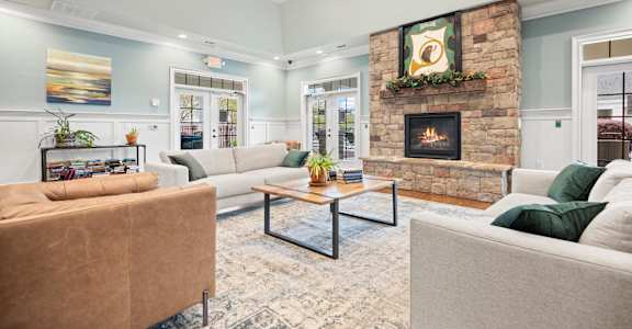 a living room with couches and a fireplace