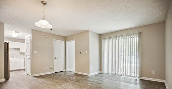 an empty living room with a large window