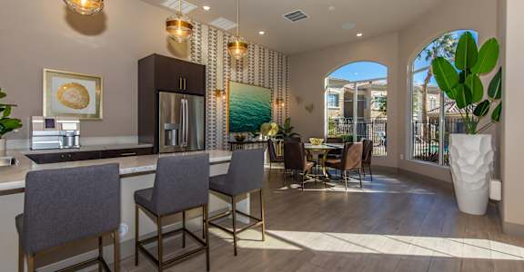 A modern kitchen with a dining area and a view of the backyard.
