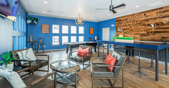 A living room with a blue wall and a wooden floor.