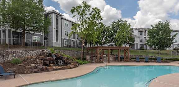 the preserve at ballantyne commons swimming pool with trees and apartment buildings