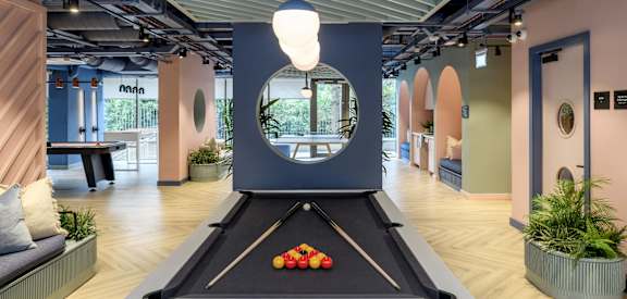 a pool table in a gym with fruit on it