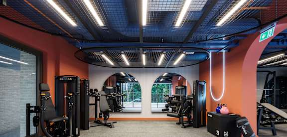 a gym with exercise equipment and a large window