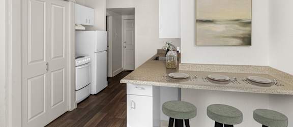 A kitchen with a table set for two with a painting hanging on the wall.