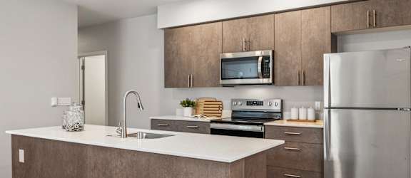 a kitchen with an island and stainless steel appliances