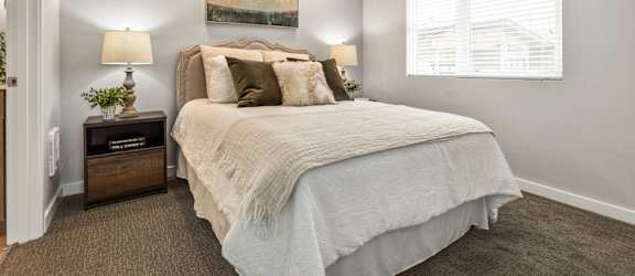 a bedroom with a large bed and a window