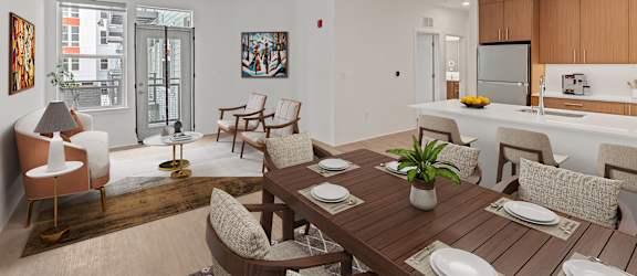 A modern dining room with a wooden table and chairs.