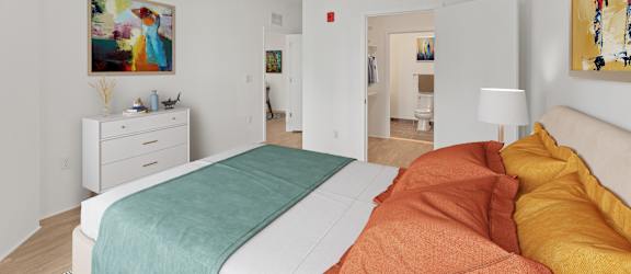 A bedroom with a bed, nightstand, and a painting on the wall.