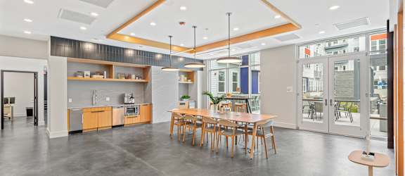 A modern open space with a kitchen, dining area, and a bar.