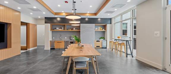 A modern kitchen with a dining table and chairs.