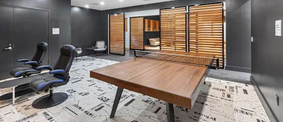 A conference room with a long table and chairs.