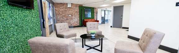 A room with a green wall and a flat screen TV mounted on it. at The Onyx at 695, Nevada, 89503