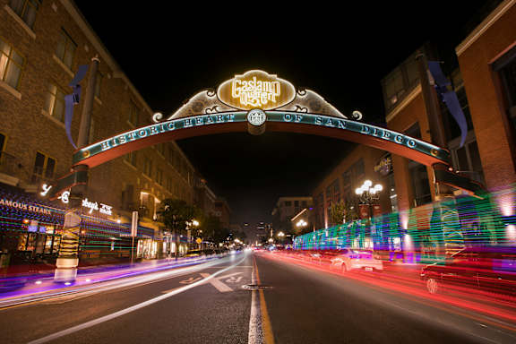 A long exposure shot of a street at night with a sign that reads "Casa Grande".