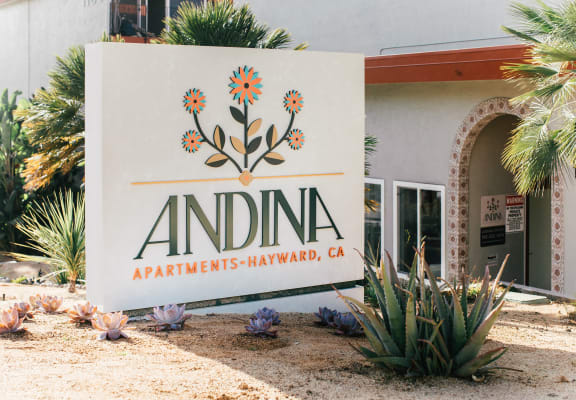 White monument sign reads Andina in front of apartment building