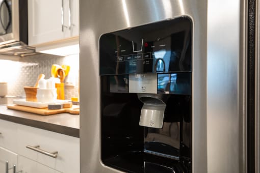 a stainless steel refrigerator with a coffee maker inside