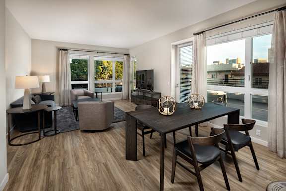 A living room with a wooden floor and furniture.