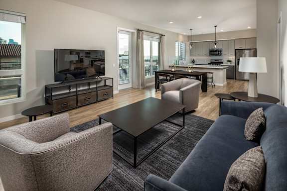A modern living room with a grey sofa and a black coffee table.