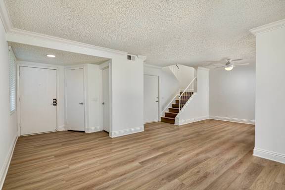 A room with wooden floors and white walls.