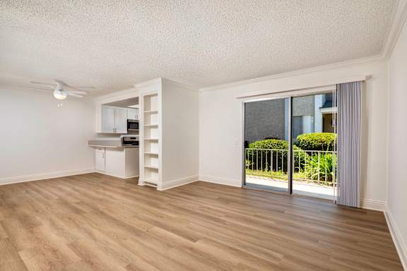 A room with a sliding glass door leading to a garden.