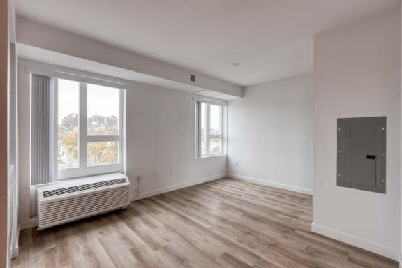 A room with a window and a radiator on the wall.