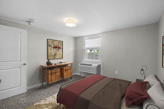 A bedroom with a bed, dresser, and window.