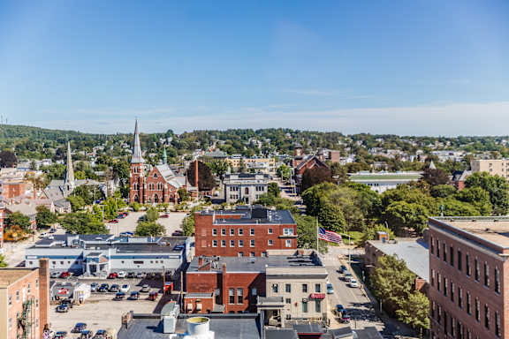 A cityscape with a church steeple in the distance.