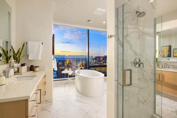a bathroom with a tub and a shower and a view of the city at Two Lincoln Tower Apartments, Bellevue, WA, 98004