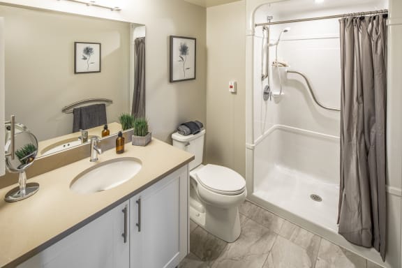 A bathroom with a shower toilet and sink