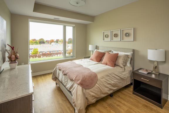 A bedroom with a bed and a large window