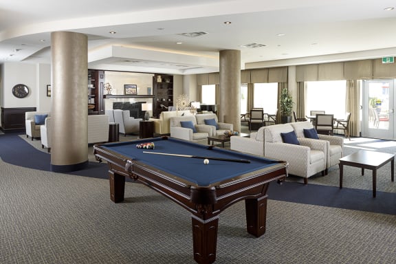 A large room with a pool table in the middle of it