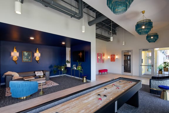a large room with a pool table and paintings on the wall