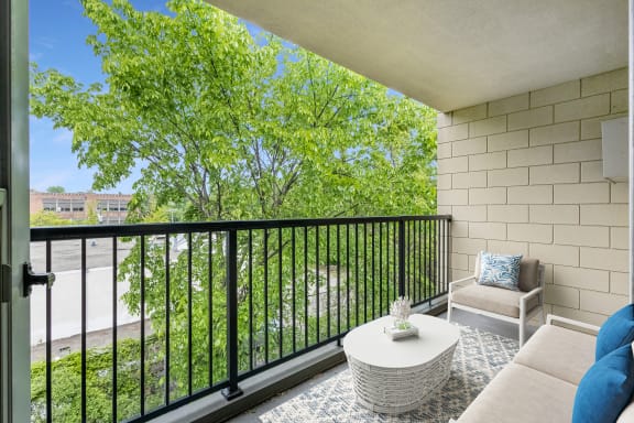 a living room with a couch and a table on a balcony