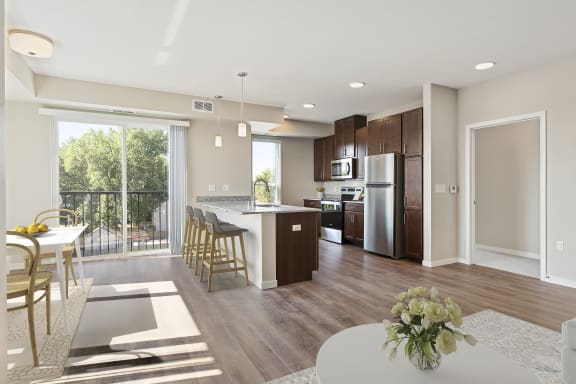 a living room and kitchen with a table and chairs