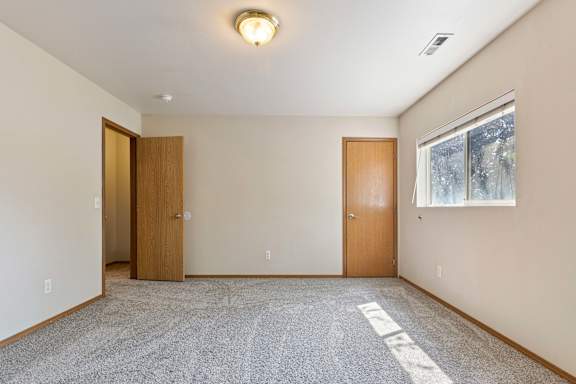 an empty room with a window and door
