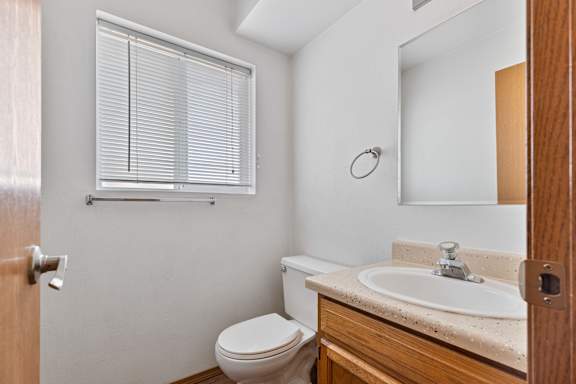 a bathroom with a toilet sink and mirror