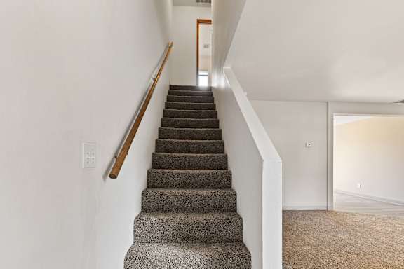 a stairway in a house with carpet