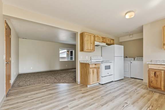 a kitchen with white appliances and wooden cabinets