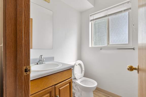 a bathroom with a toilet sink and mirror