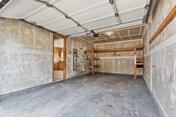 a large room with concrete floors and a bunk bed on the wall
